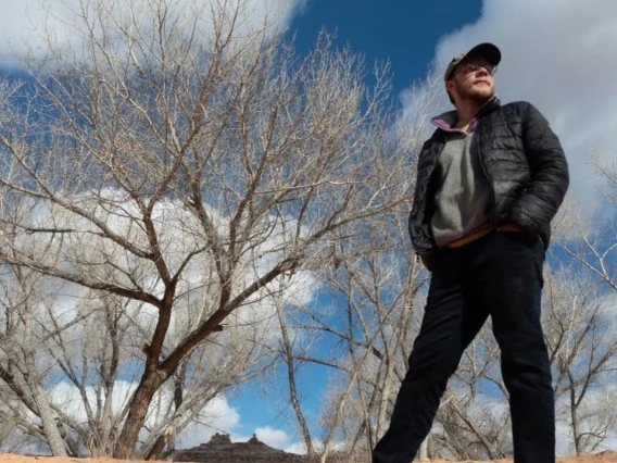 Alex Floyd standing near desert foliage
